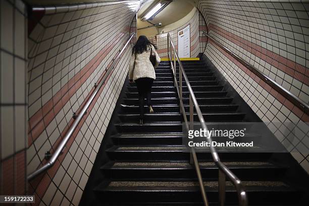 Passenger walks up stairs after leaving a train at Baker Street Underground Station on January 9, 2013 in London, England. Baker Street Station...