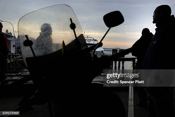 People look out over the Seastreak ferry following an early morning ferry accident during rush hour in Lower Manhattan on January 9, 2013 in New York...
