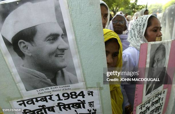 Widows of Sikhs killed in the November 1984 riots hold placards assigning blame for the massacre to senior Congress Party leaders, including then...