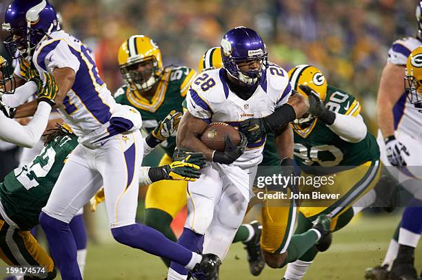 Playoffs: Minnesota Vikings Adrian Peterson in action, rushing vs Green Bay Packers B.J. Raji at Lambeau Field. Green Bay, WI 1/5/2013 CREDIT: John...