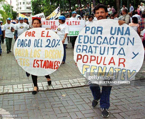 Public employees protest in the streets surrounding the National Congress in Caracas, 22 September 1999. Empleados publicos marchan en las afueras...