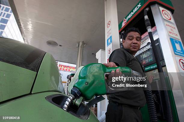 An attendant fills the tank of a car at a Pemex station in Mexico City, Mexico, on Tuesday, Jan. 8, 2013. Mexico’s government is speeding up the...