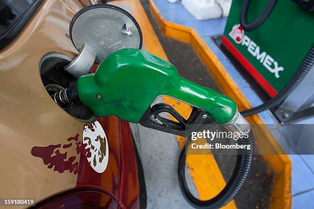 Taxi gets its tank filled with gasoline at a Pemex station in Mexico City, Mexico, on Tuesday, Jan. 8, 2013. Mexico’s government is speeding up the...