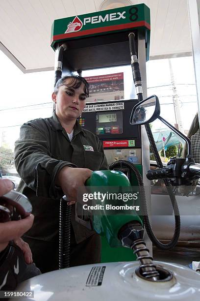 An attendant fills the tank of a motorcycle with gasoline at a Pemex station in Mexico City, Mexico, on Tuesday, Jan. 8, 2013. Mexico’s government is...