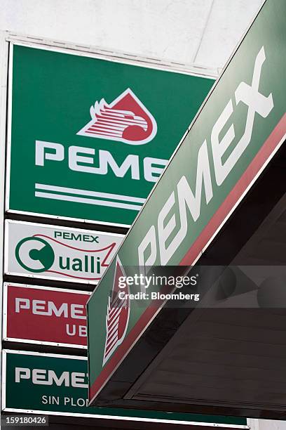 Pemex signage hangs at a station in Mexico City, Mexico, on Tuesday, Jan. 8, 2013. Mexico’s government is speeding up the removal of subsidies on...