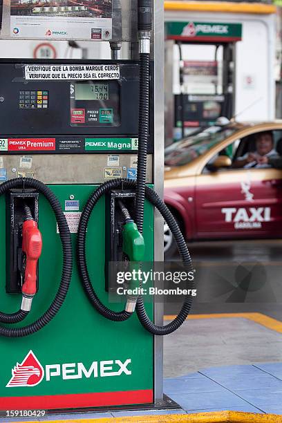 Taxi driver gets his vehicle's tank filled with gasoline at a Pemex station in Mexico City, Mexico, on Tuesday, Jan. 8, 2013. Mexico’s government is...