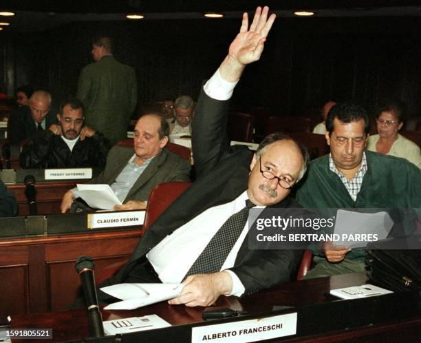 Alberto Franceschi, ex-leader of a parliamentary group opposing Project Venezuela, raises his hand 29 August 1999 in Congress. Alberto Franceschi,...