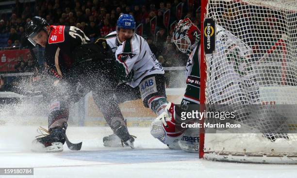 Ivan Ciernik of Hannover and Sergio Somma of Augsburg battle for the puck in front of the net during the DEL match between Hannover Scorpions and...