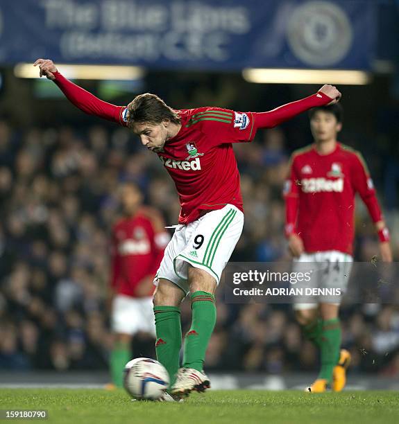 Swansea City's Spanish midfielder Miguel Michu shoots at the goal against Chelsea during the English League Cup first leg semi-final football match...