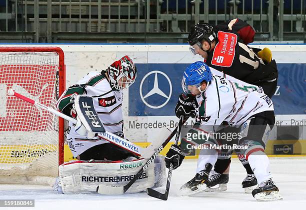 Martin Hlinka of Hannover fails to score over Patrick Ehelechner , goaltender of Augsburg during the DEL match between Hannover Scorpions and...