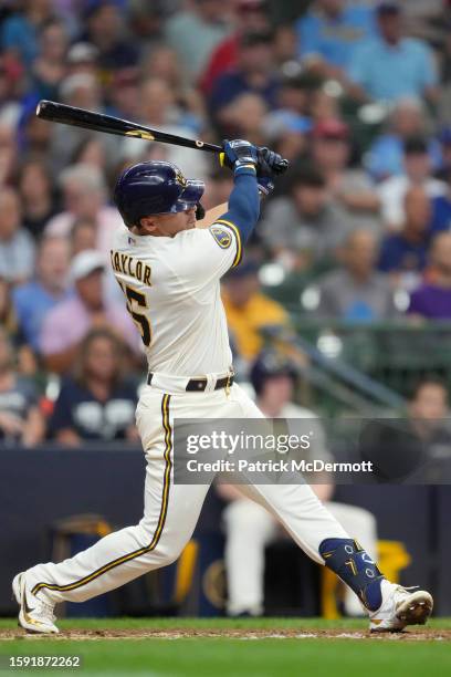 Tyrone Taylor of the Milwaukee Brewers hits a two-run home run in the seventh inning against the Cincinnati Reds at American Family Field on July 26,...