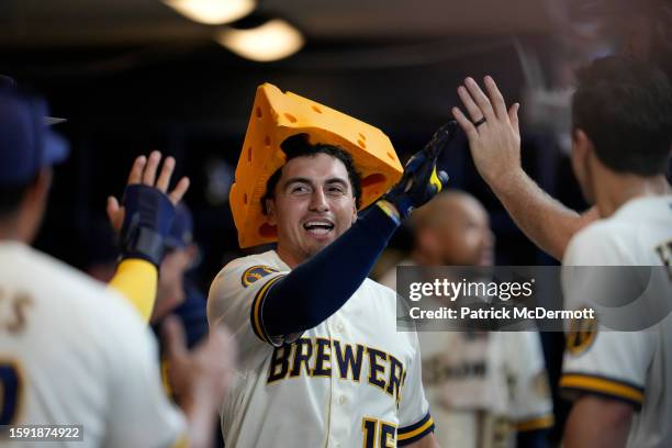Tyrone Taylor of the Milwaukee Brewers celebrates in the dugout after hitting a two-run home run in the seventh inning against the Cincinnati Reds at...