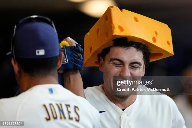 Tyrone Taylor of the Milwaukee Brewers celebrates in the dugout after hitting a two-run home run in the seventh inning against the Cincinnati Reds at...