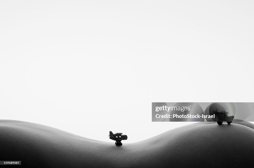 Miniature toy aircraft on a woman's torso