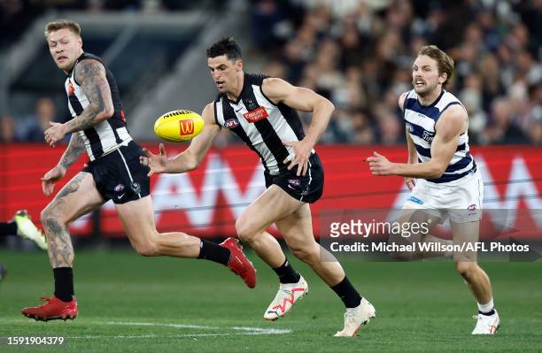 Scott Pendlebury of the Magpies and Tom Atkins of the Cats in action during the 2023 AFL Round 22 match between the Collingwood Magpies and the...