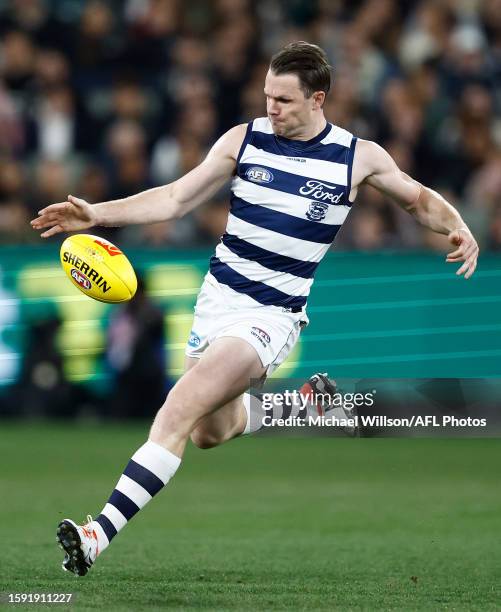 Patrick Dangerfield of the Cats kicks the ball during the 2023 AFL Round 22 match between the Collingwood Magpies and the Geelong Cats at Melbourne...