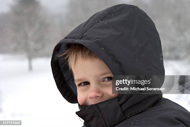 hooded boy in snow - michael virtue stock pictures, royalty-free photos & images
