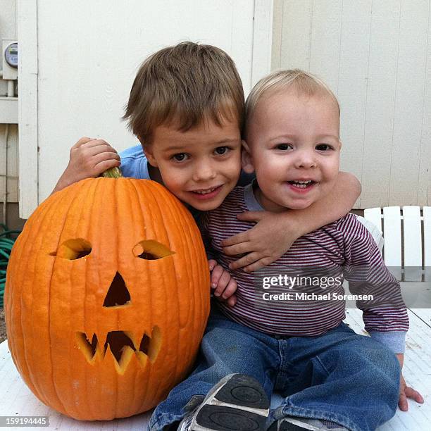 two boys with their jack-o-lantern - michael virtue stock pictures, royalty-free photos & images