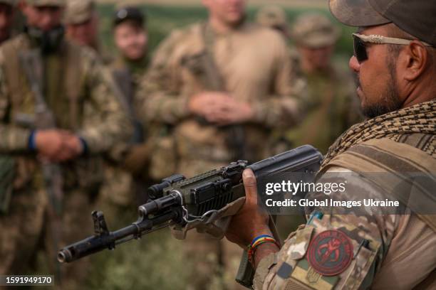 Ukrainian soldiers taking a course from a U.S. Marine instructor on the tactics on taking possession and entering an enemy trench on July 12, 2023 in...