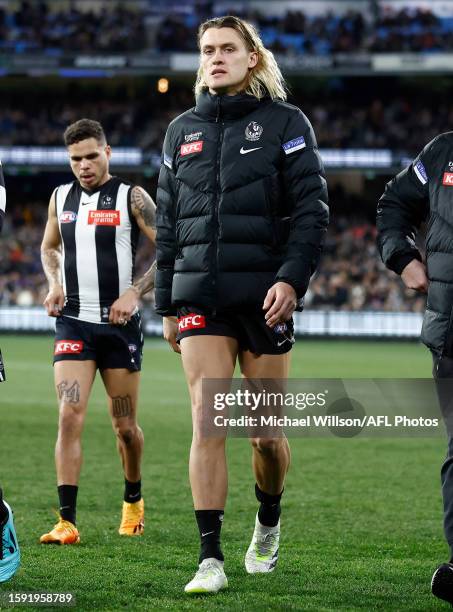 Darcy Moore of the Magpies is seen after being subbed from the game with a leg injury during the 2023 AFL Round 22 match between the Collingwood...