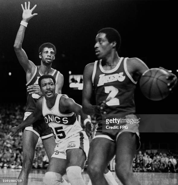 American basketball player Kareem Abdul-Jabbar, Lakers center, American basketball player Paul Silas, SuperSonics power forward, and American...
