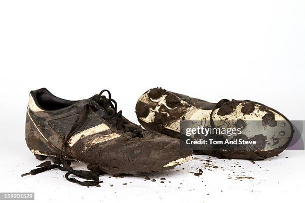 muddy football boots on a white background - studded imagens e fotografias de stock