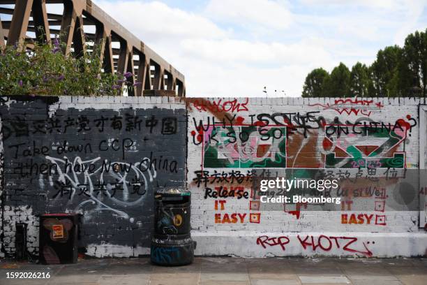 Wall covered in graffiti, including slogans critical of China's ruling party, on Brick Lane in London, UK, on Friday, Aug. 11, 2023. The wall has now...