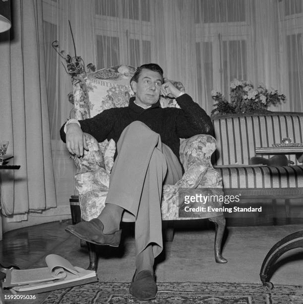 British actor Michael Redgrave seated in an armchair, January 19th 1959.