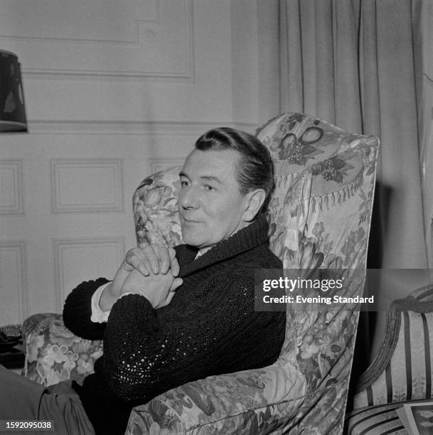 British actor Michael Redgrave seated in an armchair, January 19th 1959.