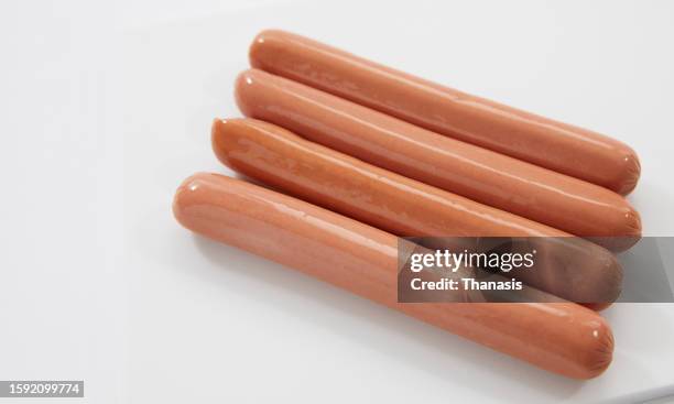close-up on hot dog sausages against a white background - insaccato foto e immagini stock
