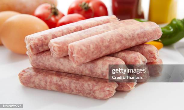 breakfast sausages against a white background - raw sausages stock pictures, royalty-free photos & images