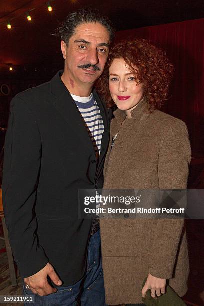 Actor Simon Abkarian and actress Blandine Bellavoir pose after Abkarian performed on stage during the premiere of 'Menelas rebetiko rapsodie' he...