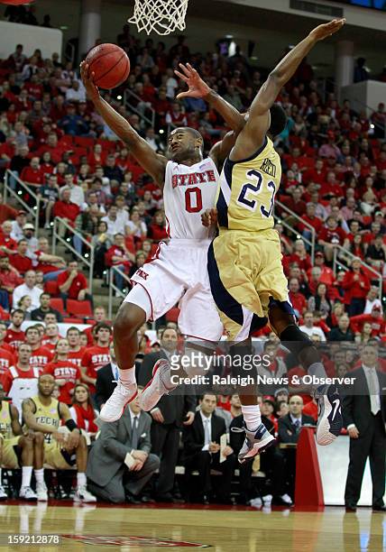State's Rodney Purvis is fouled by Georgia Tech's Brandon Reed during the first half of the Wolfpack's game against the Yellow Jackets at PNC Arena...