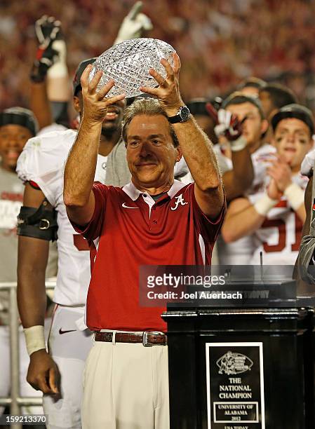 Head coach Nick Saban of the Alabama Crimson Tide raises the Coaches' Trophy after defeating the Notre Dame Fighting Irish during the 2013 Discover...