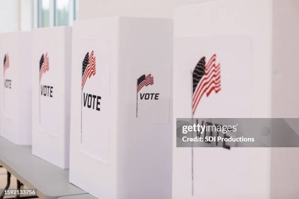 voting booths printed with american flag set up in row - american voting booth stock pictures, royalty-free photos & images