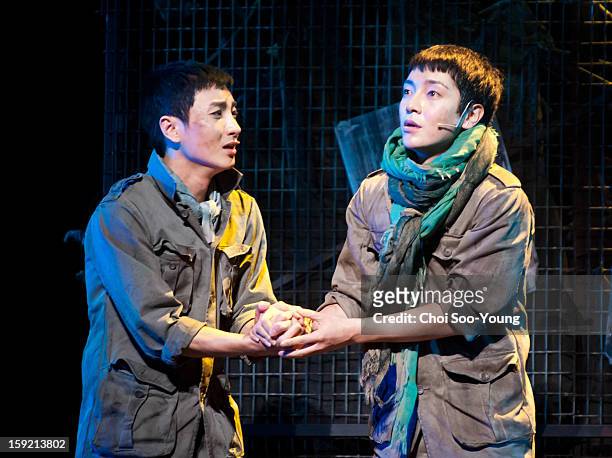 Lee-Teuk of Super Junior and Yoon-Hak of Supernova perform during the musical 'The Promise' press call at the National Theater of Korea Main Hall...