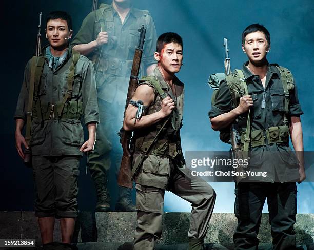 Lee-Teuk of Super Junior, Kim Moo-Yul and Ji Hyun-Woo perform during the musical 'The Promise' press call at the National Theater of Korea Main Hall...