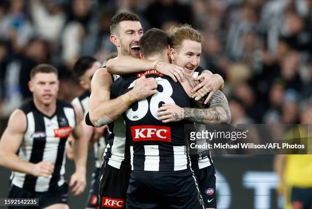 Daniel McStay, Jeremy Howe and Beau McCreery of the Magpies celebrate during the 2023 AFL Round 22 match between the Collingwood Magpies and the...