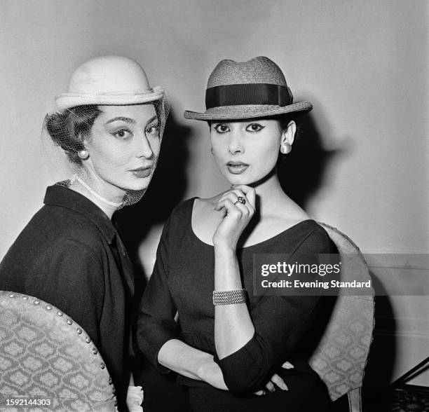 Two women modelling bowler and trilby hats, Rotten Row, London, February 26th 1958.