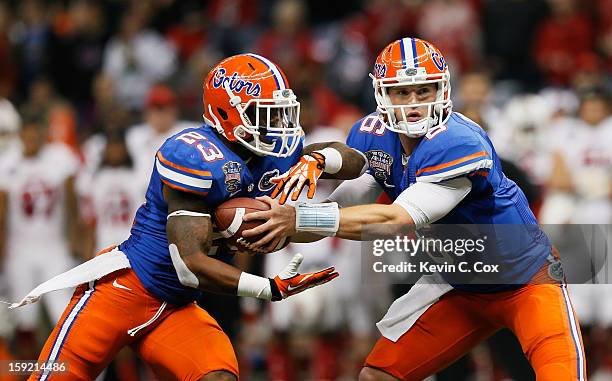 Jeff Driskel of the Florida Gators and Mike Gillislee of the Florida Gators run a play during the Allstate Sugar Bowl at Mercedes-Benz Superdome on...