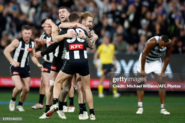 Daniel McStay, Jeremy Howe and Beau McCreery of the Magpies celebrate during the 2023 AFL Round 22 match between the Collingwood Magpies and the...