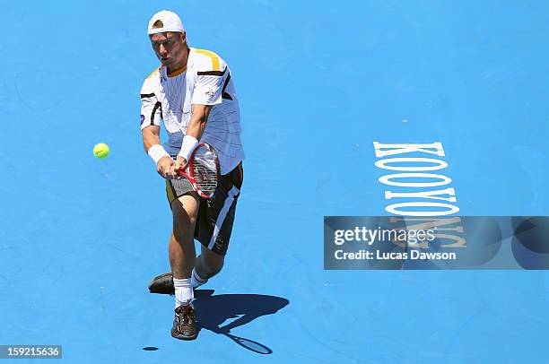 Lleyton Hewitt of Australia plays a backhand during his match against Tomas Berdych of Czech Republic during day two of the AAMI Classic at Kooyong...