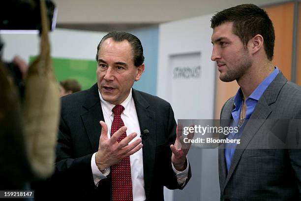 Thomas "Tom" Rogers, chief executive officer and president of Tivo Inc., left, speaks during a Bloomberg Television interview with Timothy "Tim"...