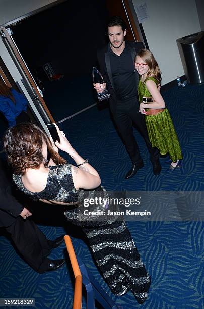 Actress Rumer Willis takes a photo of Jayson Blair and Bebe Wood backstage at the 39th Annual People's Choice Awards at Nokia Theatre L.A. Live on...