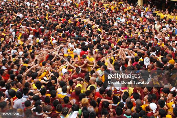 Thousands of Black Nazarene devotees try to get near the carriage carrying the Black Nazarene during the 406th feast of The Black Nazarene on January...