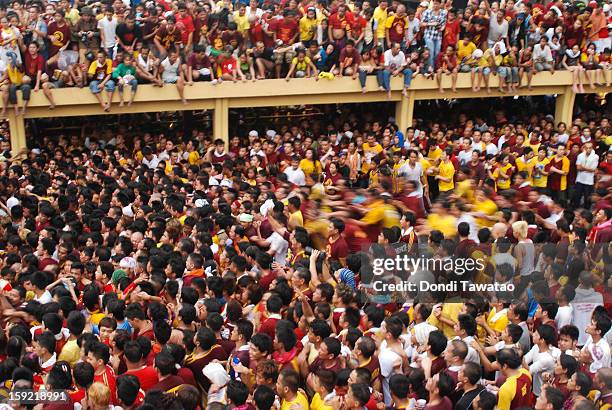 Thousands of Black Nazarene devotees try to get near the carriage carrying the Black Nazarene during the 406th feast of The Black Nazarene on January...