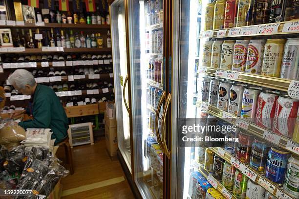 Cans of various brands of beer are displayed for sale in a liquor shop in Kawasaki, Kanagawa Prefecture, Japan, on Wednesday, Jan. 9, 2013. Suntory,...