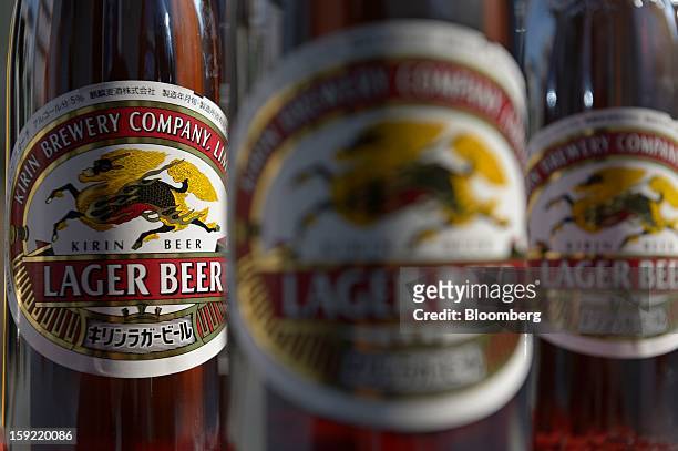 Bottles of Kirin Brewery Co. Beer are arranged for a photograph in Kawasaki, Kanagawa Prefecture, Japan, on Wednesday, Jan. 9, 2013. Suntory, Kirin...
