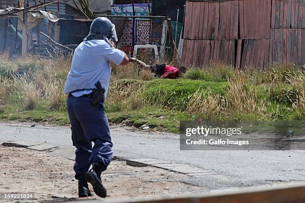 Police fire rubber bullets at strikers in retalliation to stone throwers on January 9 in Cape Town, South Africa. The farm workers of De Doorns...