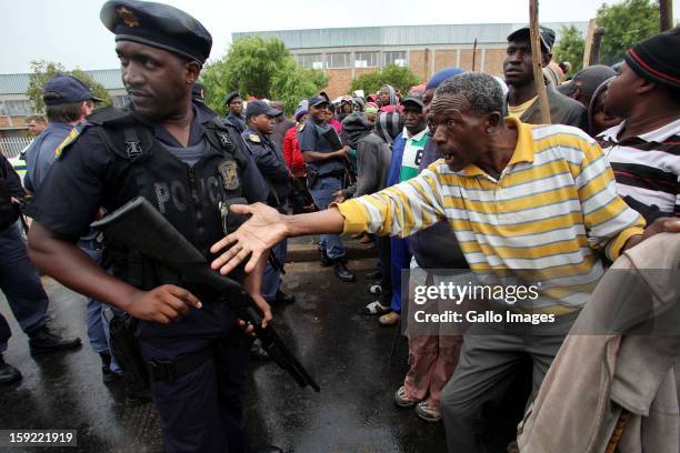 Police prevent striking farmworkers from entering the cbd of Grabouw on January 9 in Cape Town, South Africa. The farm workers of De Doorns protested...